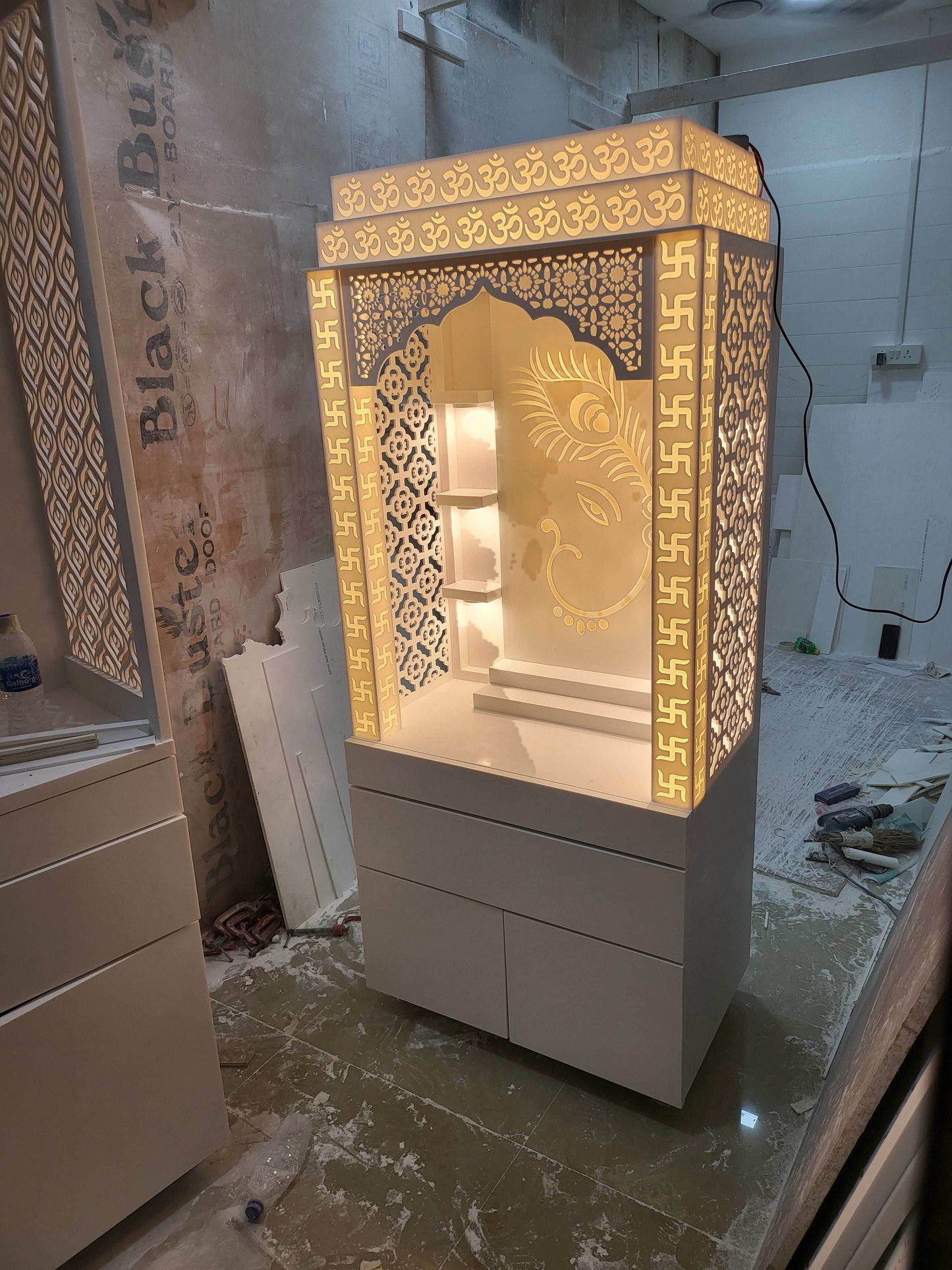 Corian mandir for home (customised pillars with swatik design and ganesha + peacock backdrop) - Home temple