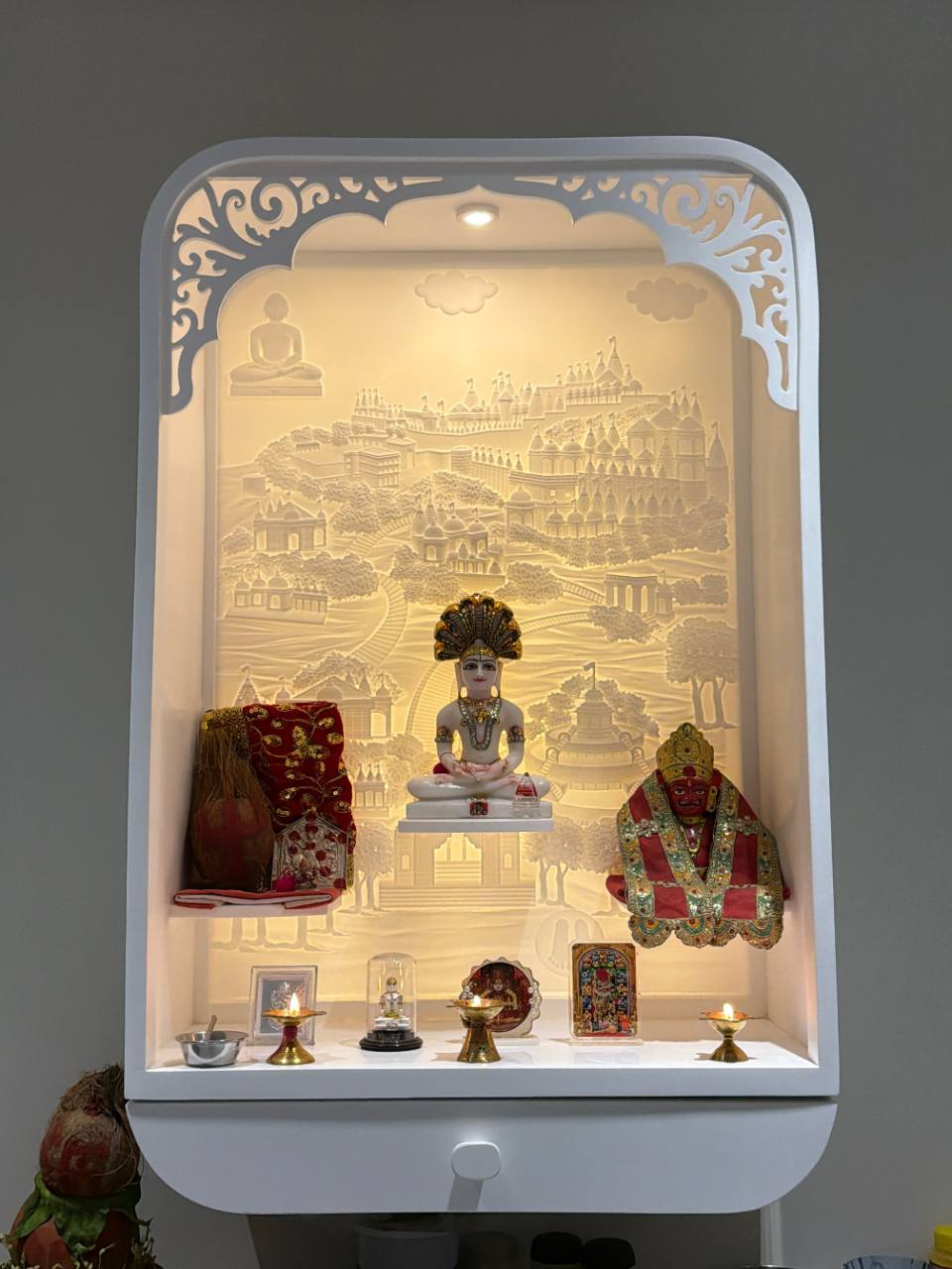 Compact Jain Corian mandir with illuminated 3D Shatrunjay path backdrop, owner-supplied photograph
