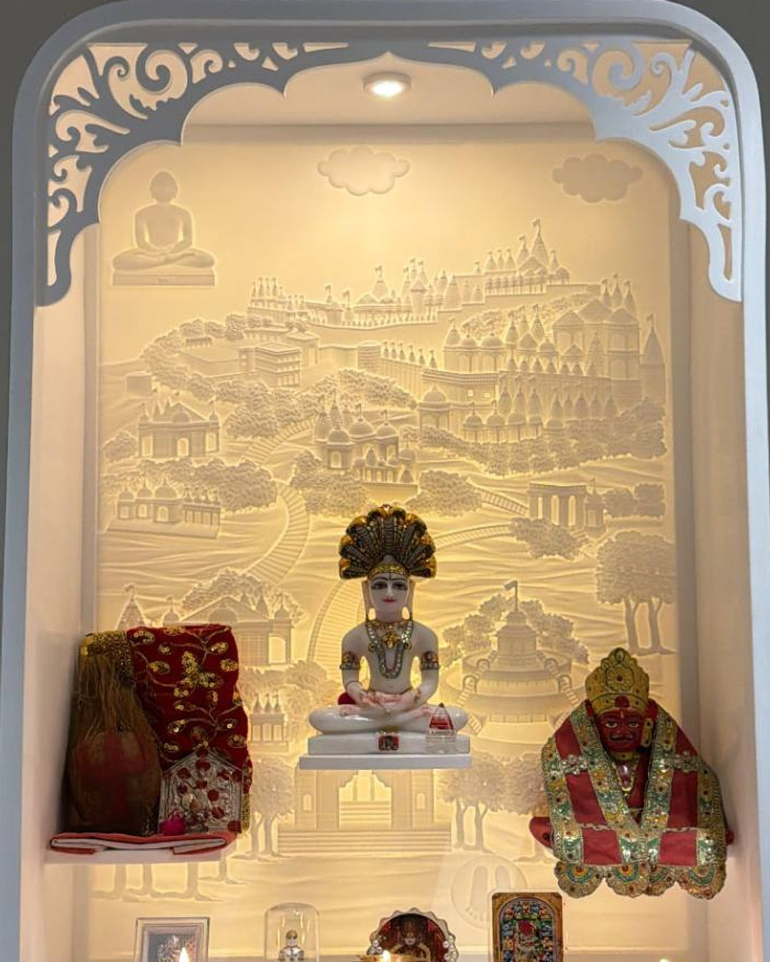 Close detail of the illuminated 3D Shatrunjay path relief in the compact Jain mandir