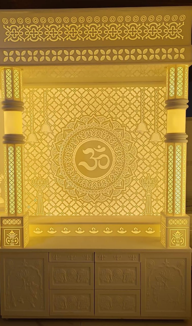 Corian mandir with intricate carvings and warm white lighting