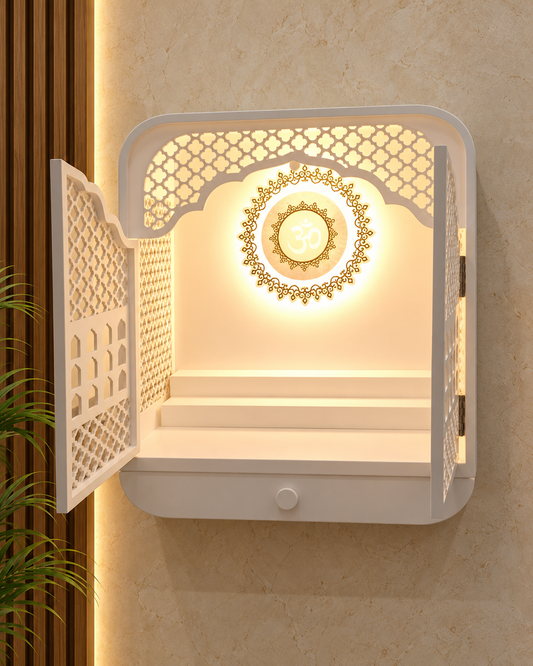 Open-door front view of the compact Corian mandir, showing the backlit Om, gold-coloured detailing and utility step; digitally styled background.