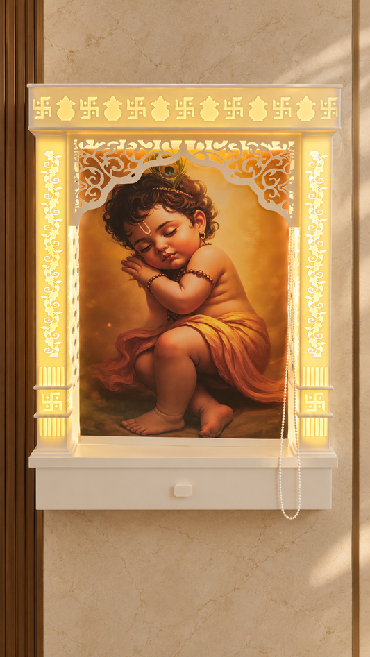 Compact white Corian wall mounted mandir with Krishna roller curtain closed and warm backlighting. Background digitally styled.