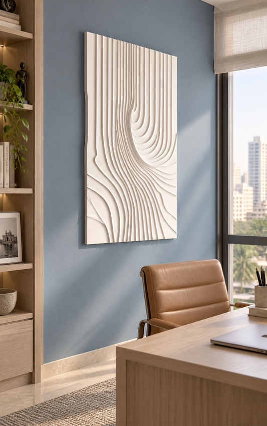Converging Fluted Current Corian wall panel, left view in a Mumbai home study with a muted blue wall, pale oak desk and tan chair.