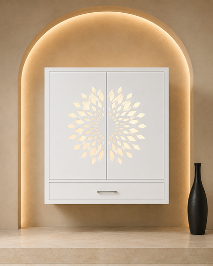 Glacier White Corian wall-mount mandir with closed pocket doors, glowing floral jali and storage drawer