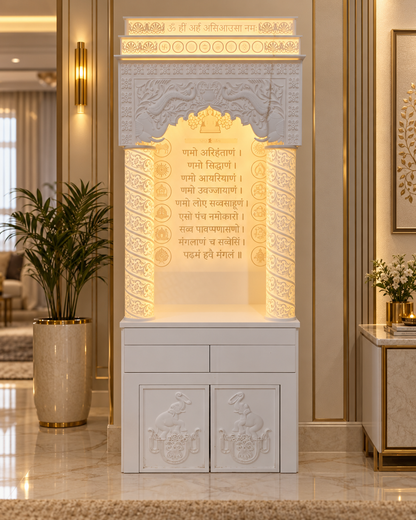 Front view of a Jain Corian mandir with Navkar Mantra artwork, illuminated carved pillars and concealed storage in a luxury home setting