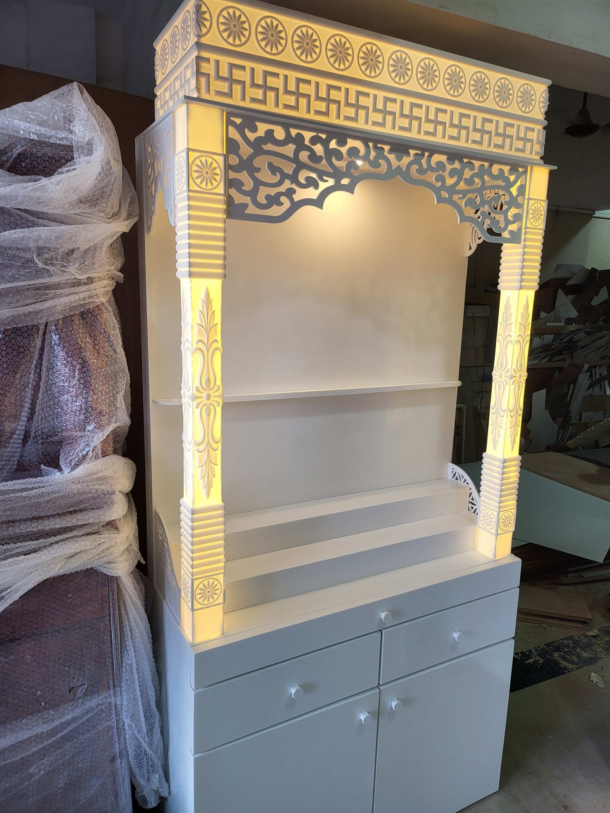 Corian mandir for home with pillars and laminated cabinet storage corian mandir mumbai