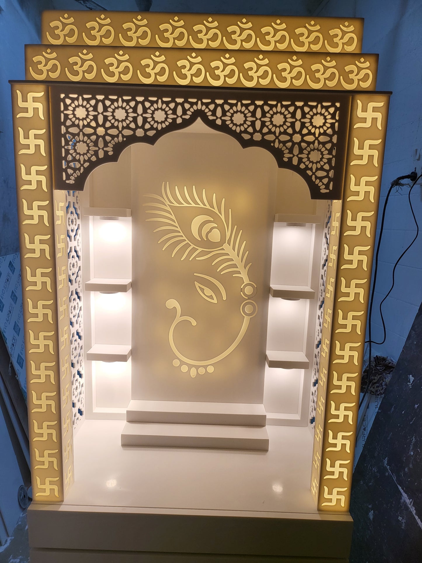 Corian mandir for home (customised pillars with swatik design and ganesha + peacock backdrop) corian mandir mumbai