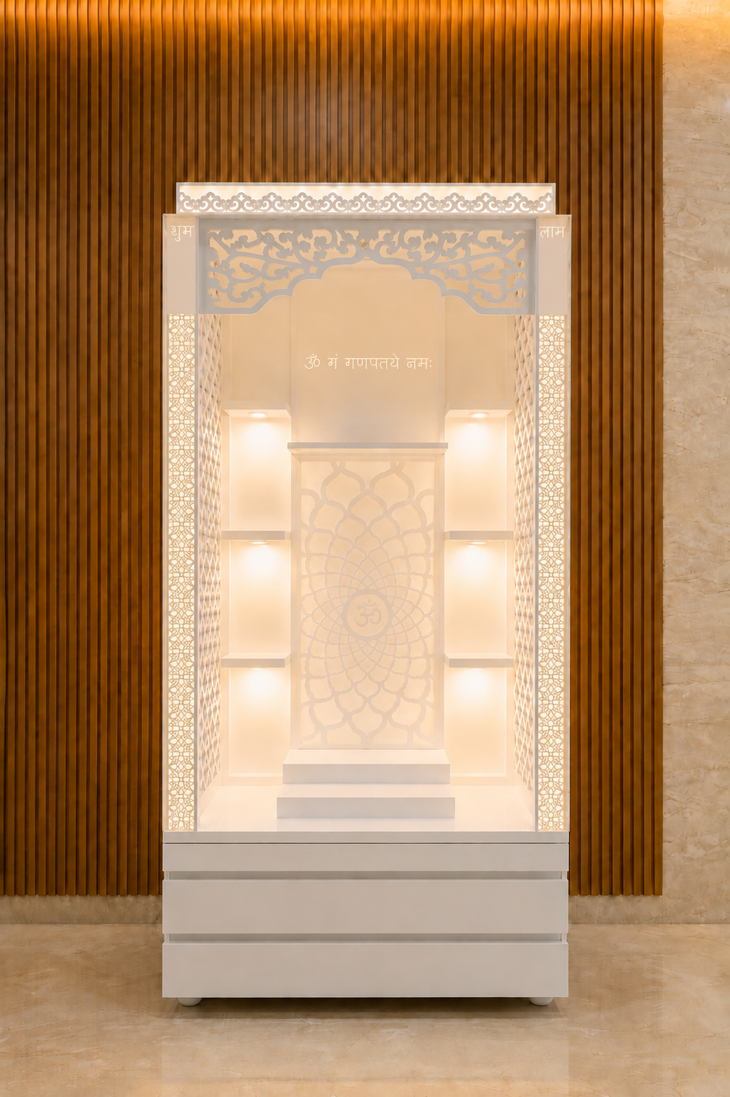 Front view of tall white backlit Corian mandir with jali panels, illuminated shelves and storage drawers