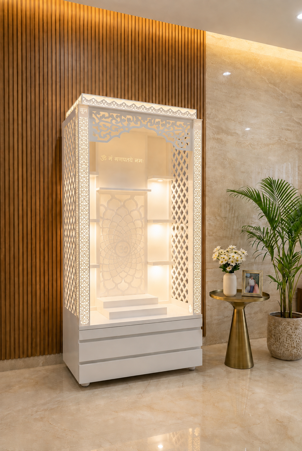 Three-quarter side view of tall white backlit Corian mandir with jali panels and storage drawers in a warm interior